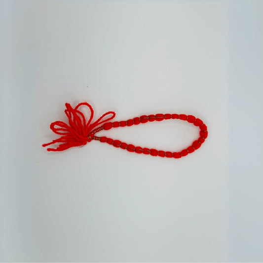 Red thread bracelet with decorative knots
